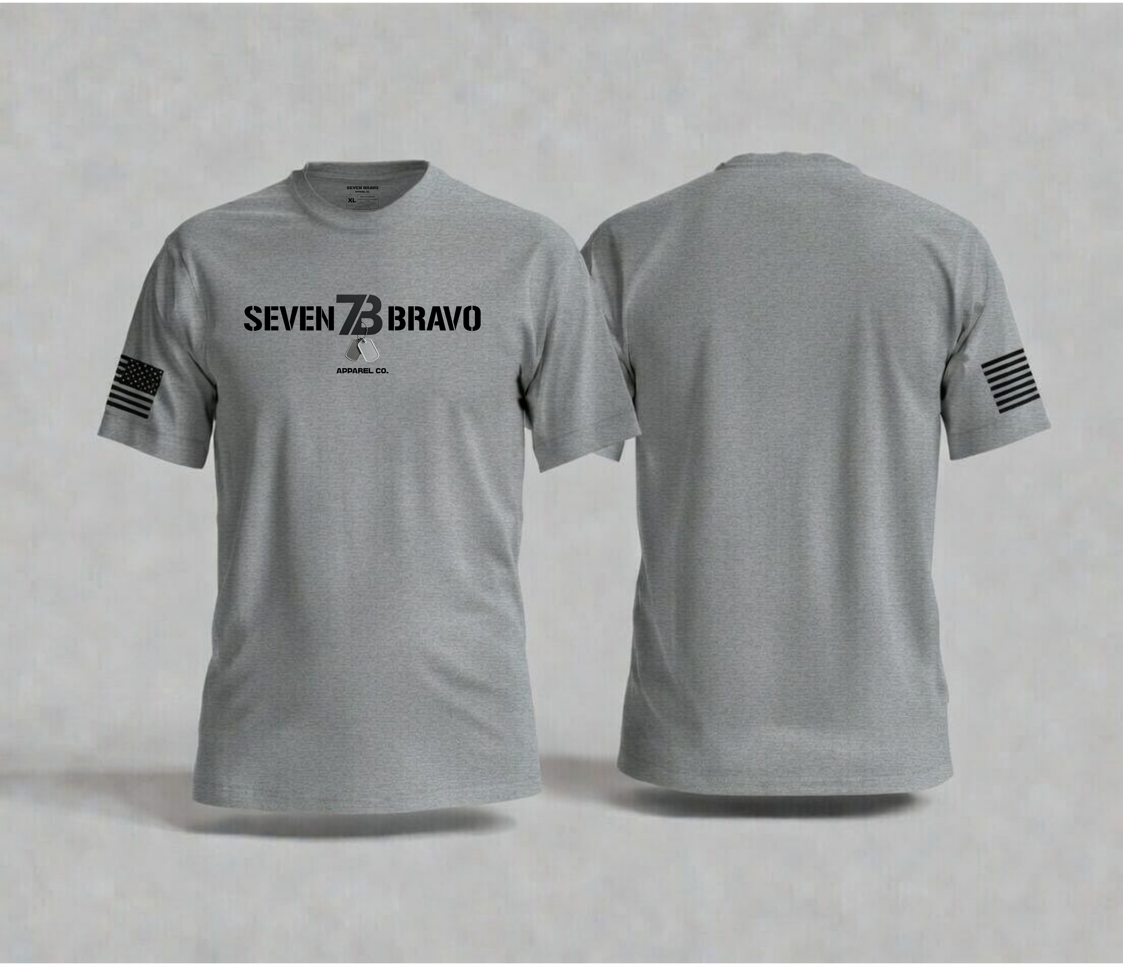 Gray t-shirt with 'Seven  Bravo' text and logos on a light gray background