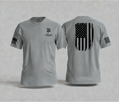 Grey t-shirt with American flag design on the back and seven bravo logo on the front